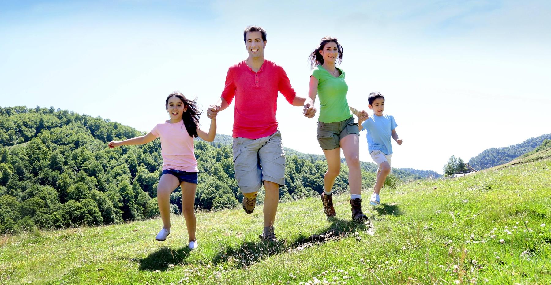 Family exercising and smiling outside