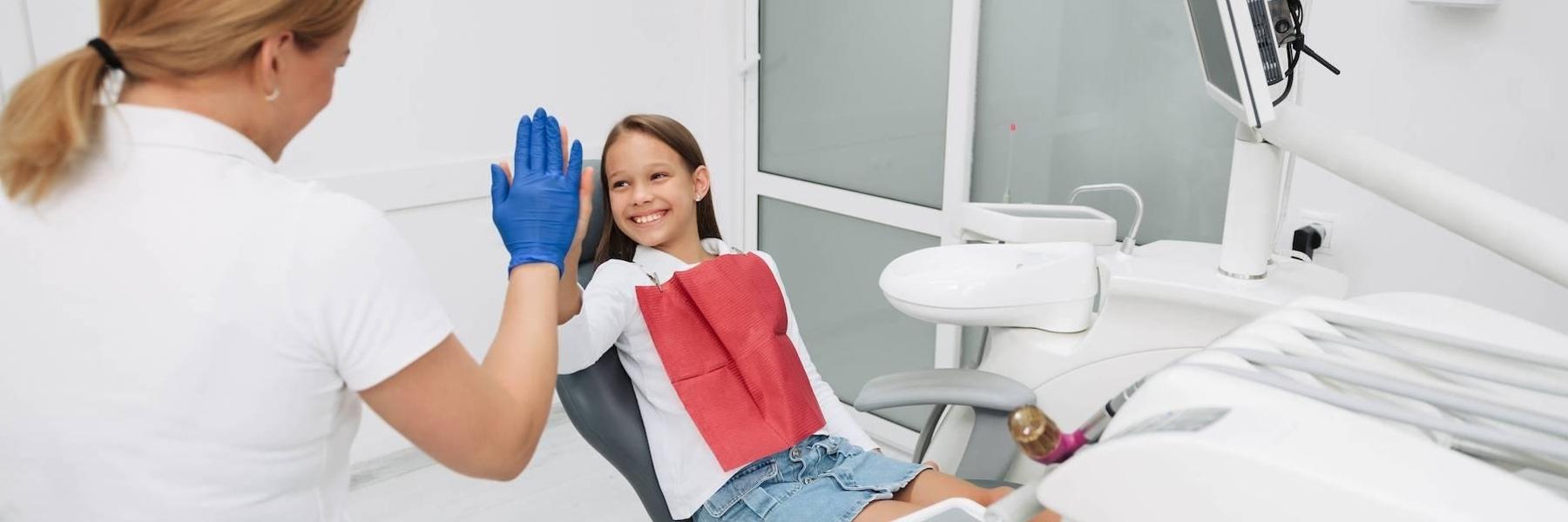 Child giving her dentist a high five